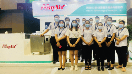 MayAir air purifiers and HVAC equipment displayed at a trade show booth with company staff, showcasing innovative air quality solutions and Chinese manufacturing expertise.